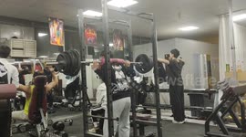 College student narrowly escapes mishap in gym: barbell squat fail caught on camera