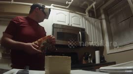 Man cooks while riding on a virtual reality roller coaster.