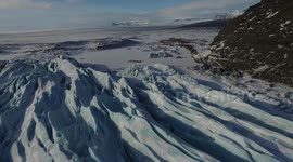 Beautiful aerial footage above structured blue glacier in Iceland