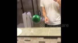Man throws ball to himself through mirror in crazy optical illusion