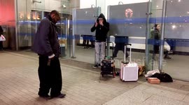 Man dancing to beat-boxing, harmonica playing busker