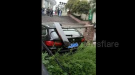 BMW crashes down stairs after driver presses accelerator by mistake