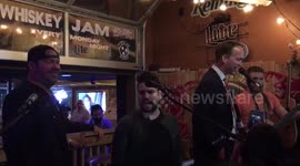 Legendary quarter back Peyton Manning singing onstage in Nashville