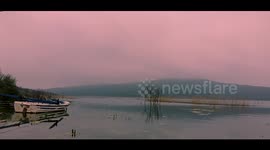 Boat rocks from side-to-side in beautiful lake time-lapse