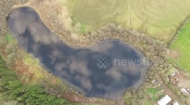 Amazing, high drone flight over cloud-covered lake