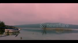 Boat rocks from side-to-side in beautiful lake time-lapse