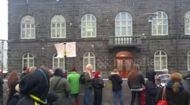 Protester throws a yoghurt at Iceland's parliament building