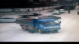 Man riding motorbike escapes being run over by lorry