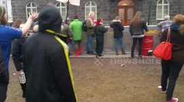 Protester throws a yoghurt at Iceland's parliament building