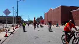 T-rex rides a penny-farthing bike on Texas road