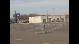 Rogue shopping trolley narrowly misses parked cars