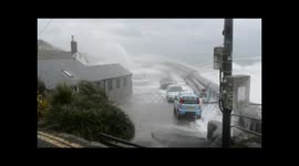Waves crash over Cars at Mousehole Harbour