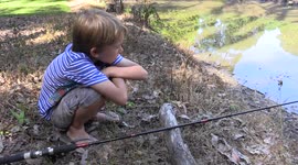 Young boy goes fishing in dam and catches an eel (almost!)