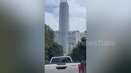 Window cleaners dressed as Santa Claus work on high rise