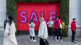Shoppers queue outside Selfridges on Oxford Street in London, UK