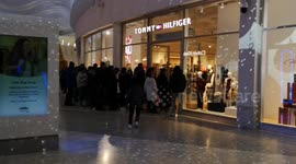 Boxing Day queues outside shops in retail park in East London. That is still playing Christmas music