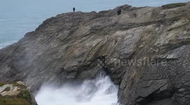 UK Weather, Yellow Warning for Flooding across the West Country, UK. The Blowing hole at Porth Island attracts Spectators, Porth Island, Cornwall UK.s