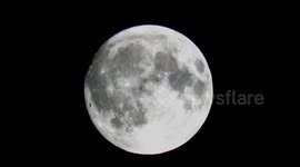 The December Full Moon known as the Cold Moon pokes through a rare break in the cloud over East London