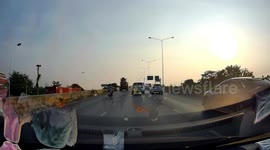 Road lamp light fall onto passing car on highway in Thailand