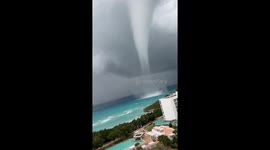 Waterspout Towers Over Shore