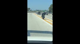 Motorcyclist Rides Sidesaddle on the Freeway