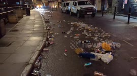 Aftermath of New Year's Celebrations Sees Lorry Drive Over a Huge Pile of Bottles and Rubbish in St Ives Cornwall