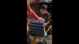 Boy becomes a screaming beacon of ecstatic joy after getting his 1st gaming console!