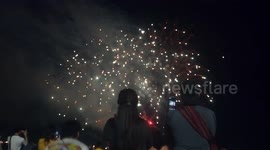 People enjoying a spectacular fireworks display at Pattaya beach Thailand.