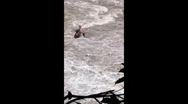 Old fisherman trapped in middle of raging river in China
