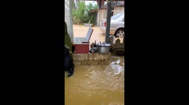 Weather-hardened food vendors keep selling in waist-deep floods
