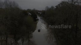 Storm Henk floods road with one car stuck in water as other motorists pass by - Risley, Derbyshire, UK