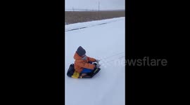 Winter joyride: grandfather creatively entertains grandson