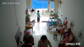 Girl tries to close glass door but it comes loose and smashes on ground