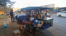 Snake sparks panic slithering into street vendor's motorcycle in Thailand