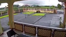 Ambulance flips over and crashes through home's yard