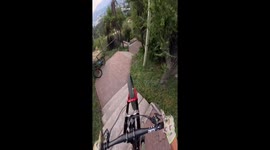 Skilled cyclist masterfully maneuvers twisting and turning narrow stairway