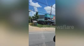 Pet dog sits behind owner's motorcycle while they ride around city