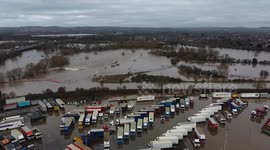 Lorries remain submerged under water after Storm Heck flooding continues to effect businesses and communities across Derbyshire, UK