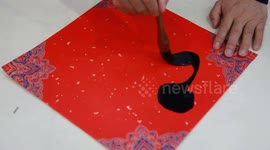 A Calligrapher Writes Fortune Characters on Red Paper ahead of the Spring Festival in Nanjing, China