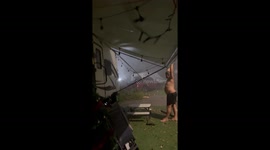 Man Holds Down Awning to Help Family Get to Safety