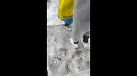 Hikers walk down slippery mountain following snow in China