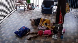 Snake slithers towards mother and daughter as they sleep on floor