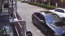 House gate topples over narrowly missing new BMW parked outside