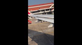 Airport ground staff wish departing passengers Happy New Year