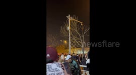 A citizen launches Gatling fireworks on a windowsill, surprising visitors in Tianjin, China
