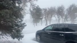 Blizzard conditions and snow drifts making it hard for people to get around town