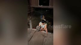 Clumsy man falls while rolling heavy pot on plank up to his house