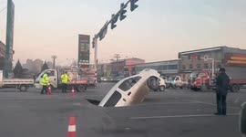 Car plunges into massive sinkhole opened up on Chinese road