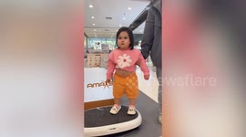Toddler looks hilarious standing on vibrating plate exercise machine