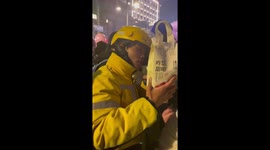 Delivery rider tries to find customer in New Year crowds
